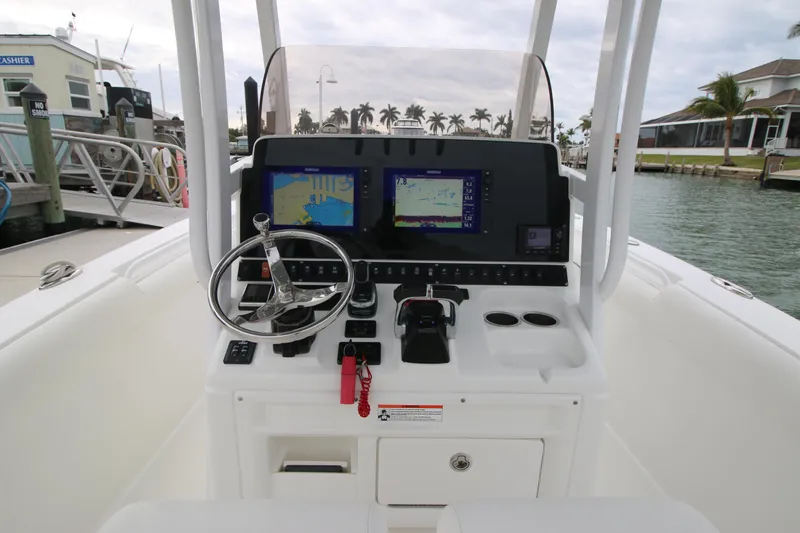 Slide: The Image of 2016 Sea Hunt Gamefish 30 helm with navigation screens and steering wheel. - 11