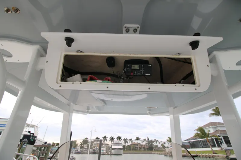 Slide: The Image of 2016 Sea Hunt Gamefish 30 boat console storage with electronic equipment. - 12