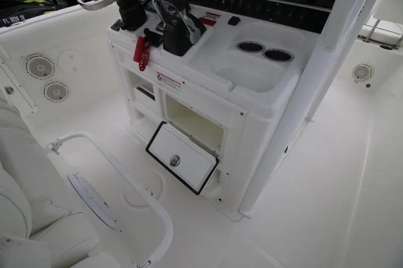 Slide: The Image of 2016 Sea Hunt Gamefish 30 interior with console, storage, and cup holders. - 16