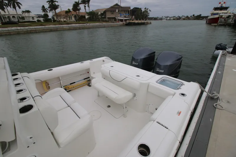 Slide: The Image of 2016 Sea Hunt Gamefish 30 boat docked, featuring spacious seating and dual engines. - 18