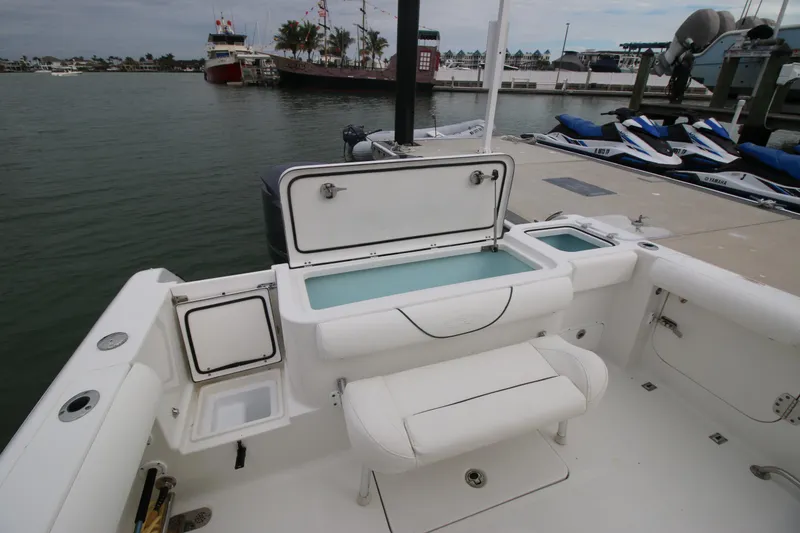 Slide: The Image of 2016 Sea Hunt Gamefish 30 boat interior with open storage compartments at dock. - 20