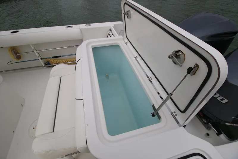 Slide: The Image of 2016 Sea Hunt Gamefish 30 boat with open storage compartment. - 23