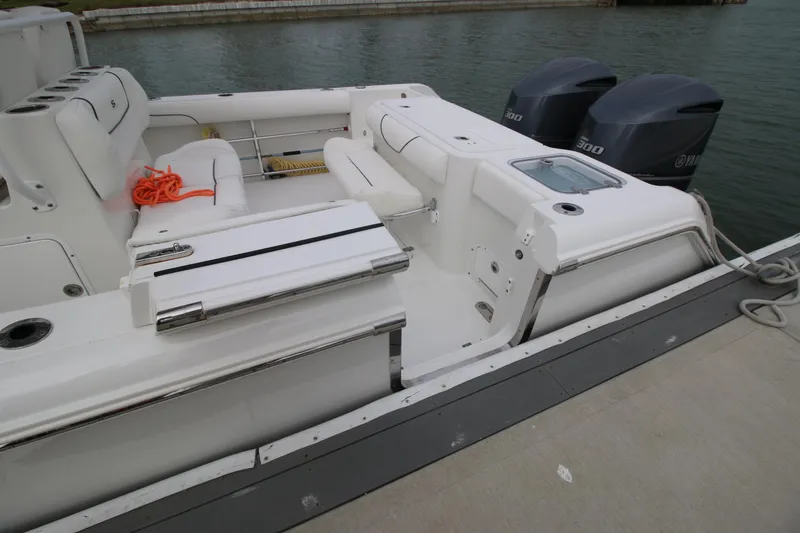 Slide: The Image of 2016 Sea Hunt Gamefish 30 boat with dual engines docked by the water. - 25