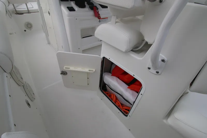 Slide: The Image of 2016 Sea Hunt Gamefish 30 interior storage compartment with life jackets. - 26