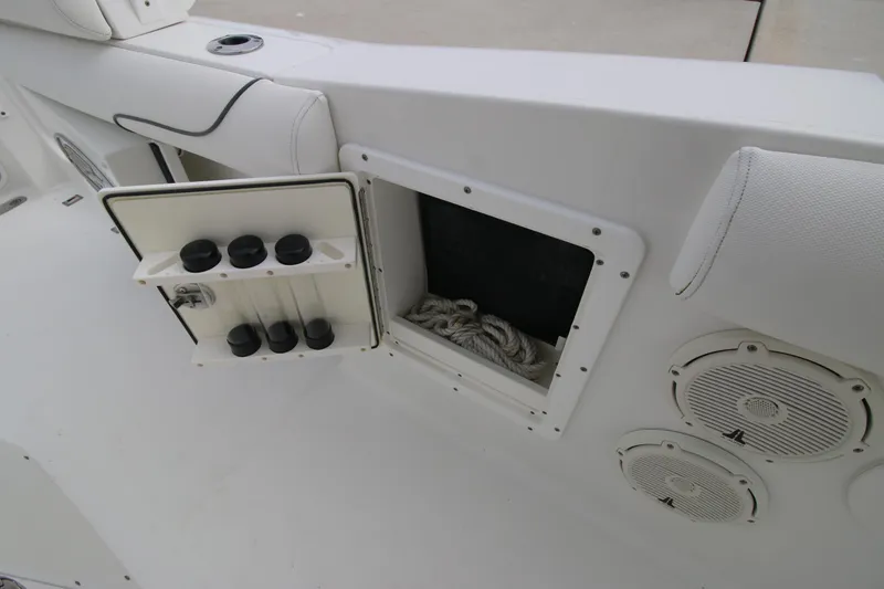 Slide: The Image of 2016 Sea Hunt Gamefish 30 boat storage compartment with speakers and rope. - 27