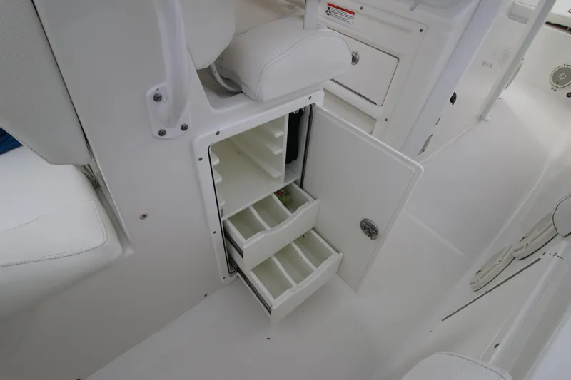 Slide: The Image of 2016 Sea Hunt Gamefish 30 tackle storage compartment with open drawers. - 28