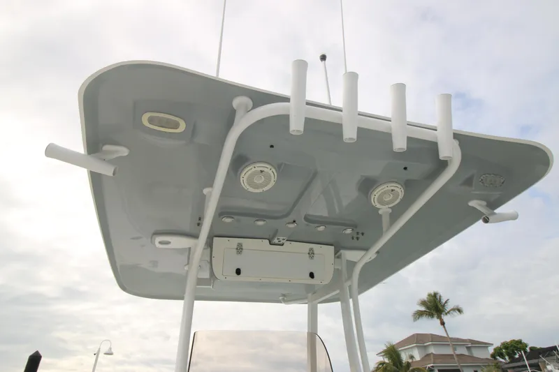 Slide: The Image of 2016 Sea Hunt Gamefish 30 T-top with rod holders and speakers, under a cloudy sky. - 32