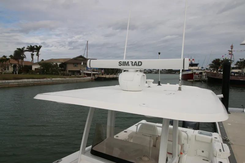 Slide: The Image of 2016 Sea Hunt Gamefish 30 boat with Simrad radar, docked in a marina. - 35