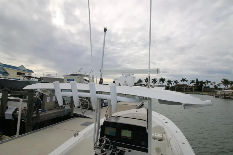 Slide: The Image of 2016 Sea Hunt Gamefish 30 boat docked under cloudy skies. - 36