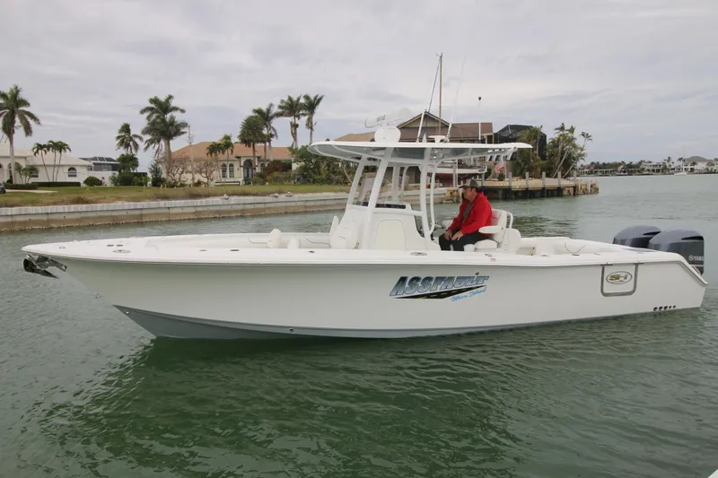 Slide: The Image of 2016 Sea Hunt Gamefish 30 boat on water, with person in red jacket. - 4
