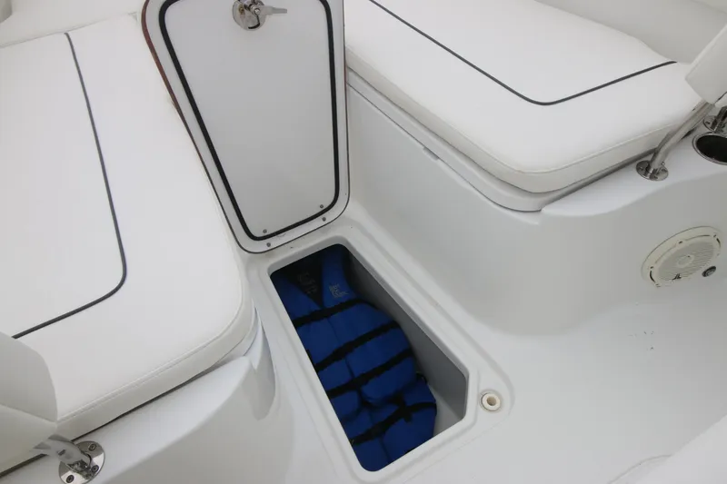 Slide: The Image of 2016 Sea Hunt Gamefish 30 boat storage compartment with life jacket. - 8