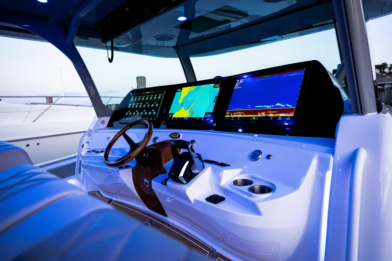 Slide: The Image of 2023 HCB 65 Estrella boat cockpit with advanced navigation displays and controls. - 13