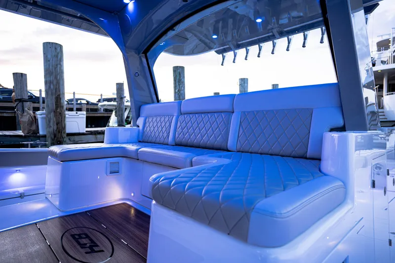 Slide: The Image of Luxurious seating on 2023 HCB 65 Estrella yacht with ambient blue lighting. - 18
