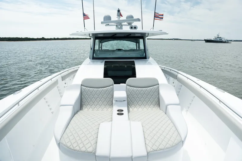 Slide: The Image of 2023 HCB 65 Estrella luxury boat with plush seating on open water. - 20