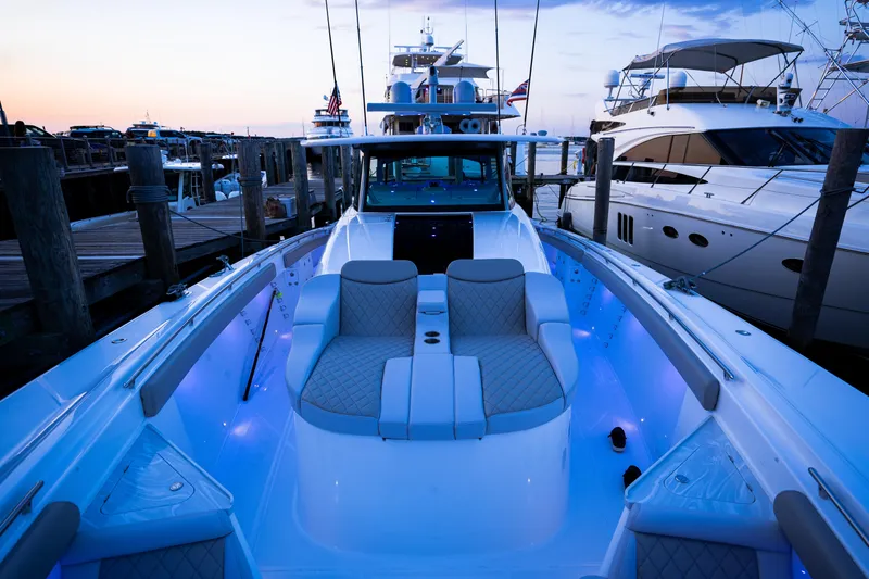 Slide: The Image of 2023 HCB 65 Estrella luxury yacht docked at sunset with illuminated seating area. - 21