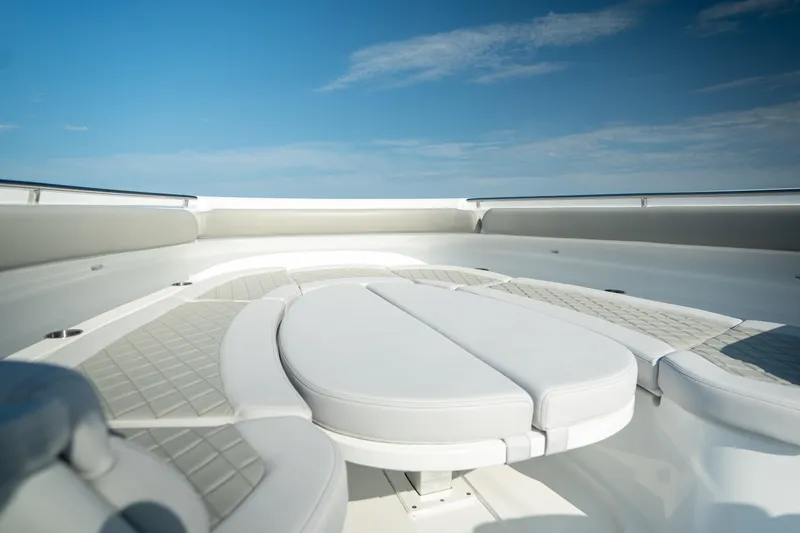 Slide: The Image of 2023 HCB 65 Estrella boat interior with luxurious seating under a clear blue sky. - 22