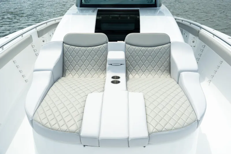 Slide: The Image of Luxurious seating on 2023 HCB 65 Estrella boat with quilted upholstery. - 25