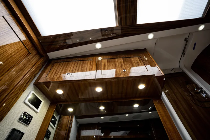 Slide: The Image of Luxurious interior of 2023 HCB 65 Estrella yacht with wood paneling and recessed lighting. - 27