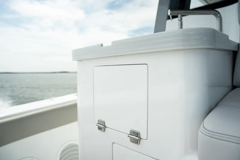 Slide: The Image of 2023 HCB 65 Estrella boat interior with sleek white cabinetry and ocean view. - 30