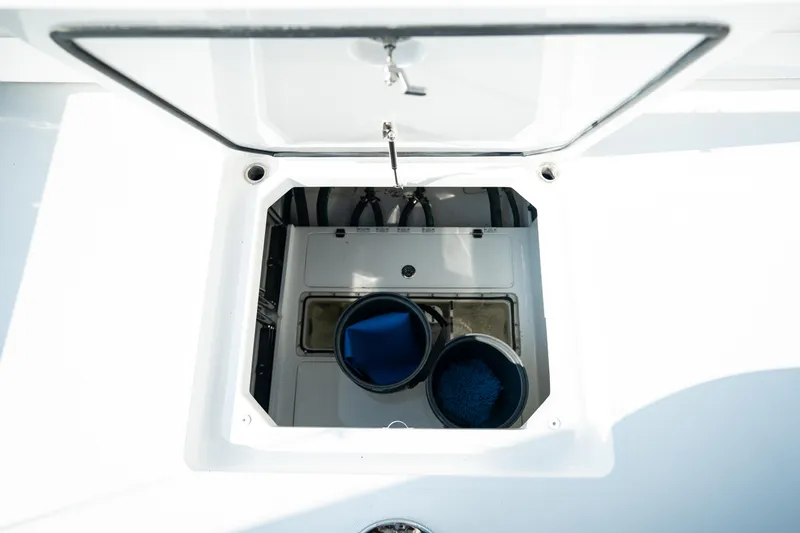 Slide: The Image of Open hatch on 2023 HCB 65 Estrella boat, showing storage compartment. - 32