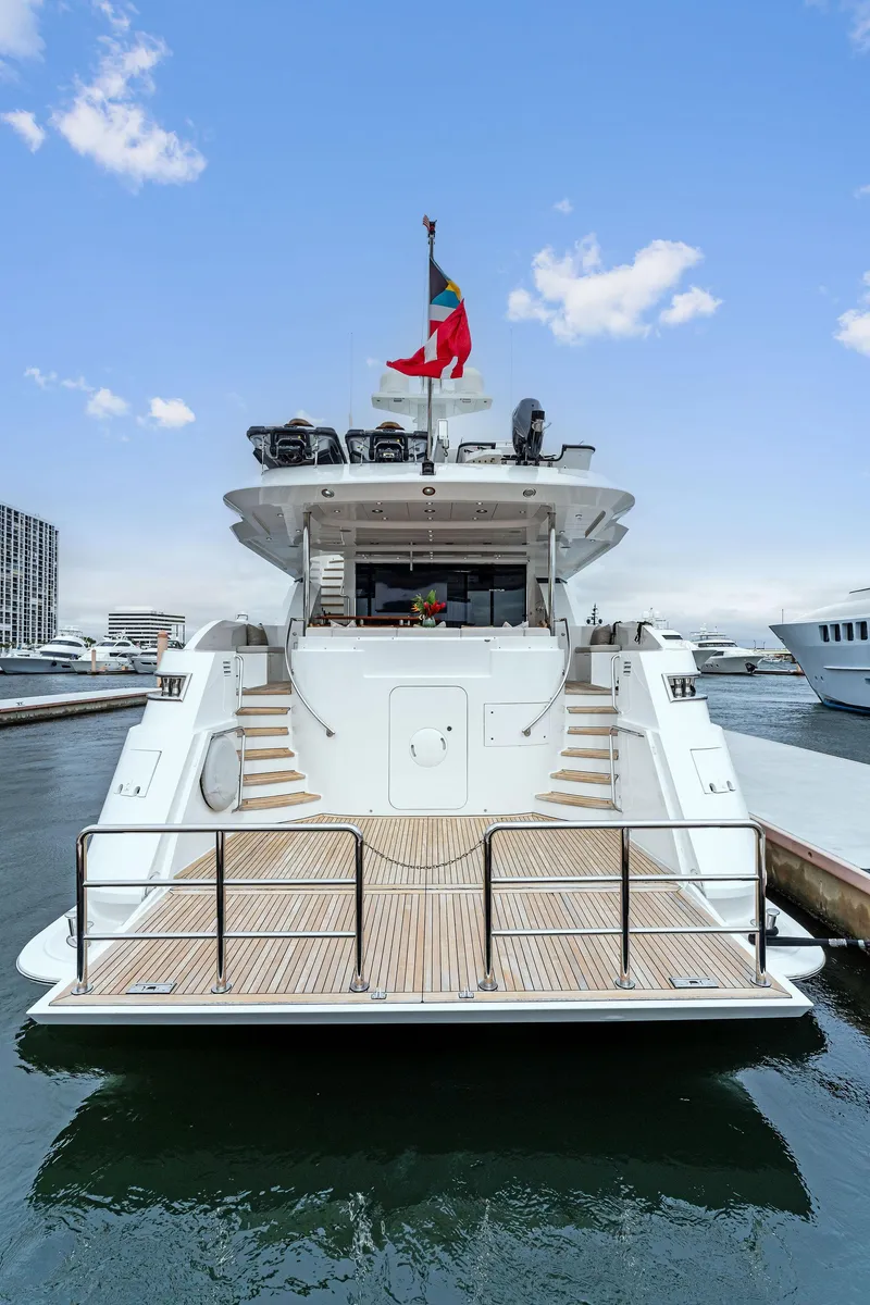 Slide: The Image of Luxury Palmer Johnson 2006 motor yacht docked at marina, featuring elegant design and spacious deck. - 12