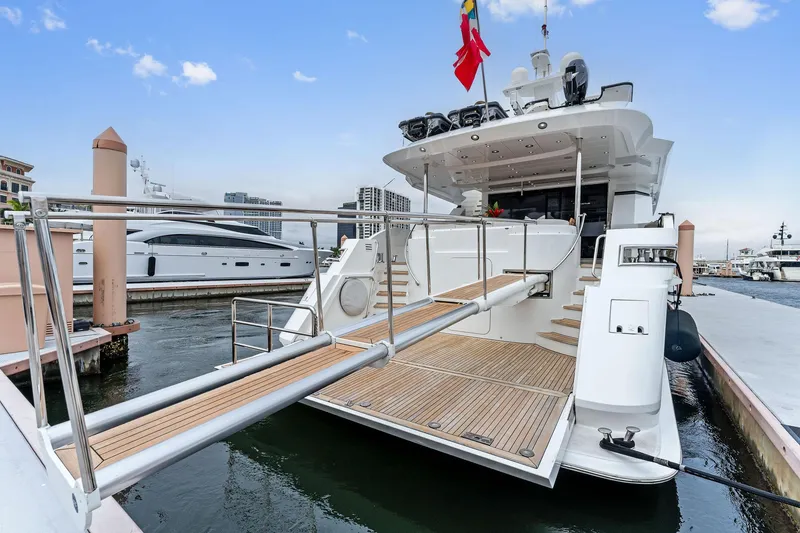 Slide: The Image of Palmer Johnson 2006 motor yacht with sleek white exterior and wooden steps. - 13