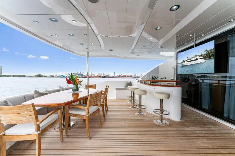 Slide: The Image of Luxurious 2006 Palmer Johnson motor yacht deck with bar and dining area. - 16