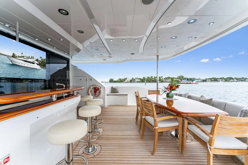 Slide: The Image of Luxurious 2006 Palmer Johnson motor yacht deck with bar and dining area overlooking the water. - 17