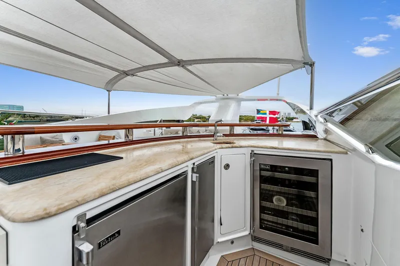 Slide: The Image of Luxurious 2006 Palmer Johnson motor yacht deck with bar and seating under canopy. - 26