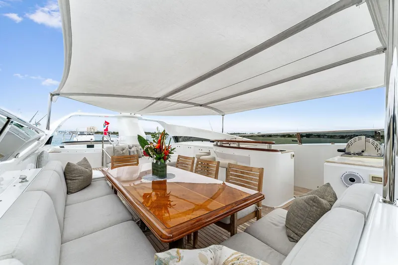 Slide: The Image of Luxurious 2006 Palmer Johnson motor yacht deck with dining area and bar under canopy. - 28