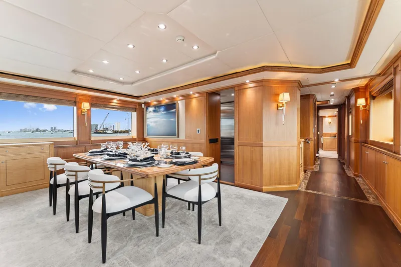 Slide: The Image of Luxurious dining area on a 2006 Palmer Johnson motor yacht, featuring elegant table settings and plush seating. - 34