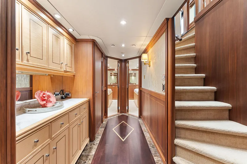 Slide: The Image of Luxurious wood-paneled hallway in 2006 Palmer Johnson motor yacht, featuring elegant cabinetry and plush bedding. - 45