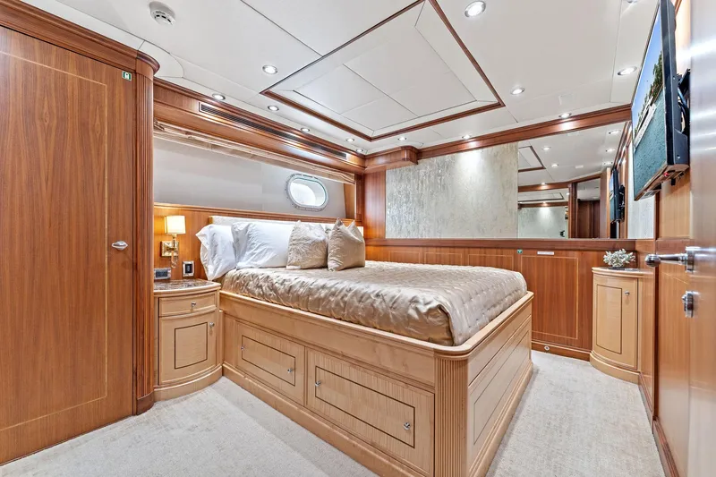 Slide: The Image of Luxurious bedroom interior of a 2006 Palmer Johnson motor yacht with elegant wood finishes. - 48