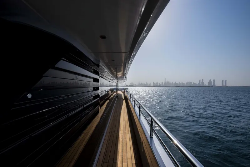 Slide: The Image of Side view of 2026 Majesty 175 yacht cruising with city skyline in background. - 20