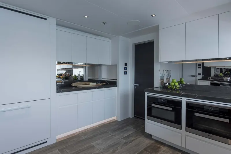Slide: The Image of Modern kitchen interior on 2026 Majesty 175 yacht, featuring sleek cabinetry and appliances. - 29
