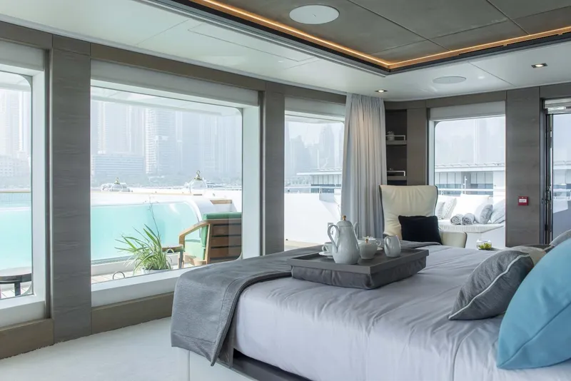 Slide: The Image of Luxurious Majesty 175 yacht bedroom with panoramic windows, elegant decor, and cityscape views, 2026 model. - 35