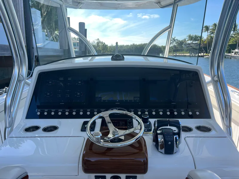 Slide: The Image of 2021 Valhalla Boatworks V-41 helm with modern controls and scenic waterway view. - 10