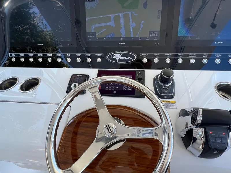 Slide: The Image of 2021 Valhalla Boatworks V-41 helm with advanced navigation controls and sleek steering wheel. - 11