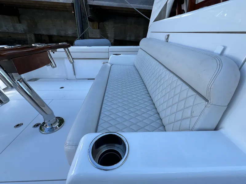 Slide: The Image of 2021 Valhalla V-41 boat interior with cushioned seating and cup holder. - 18