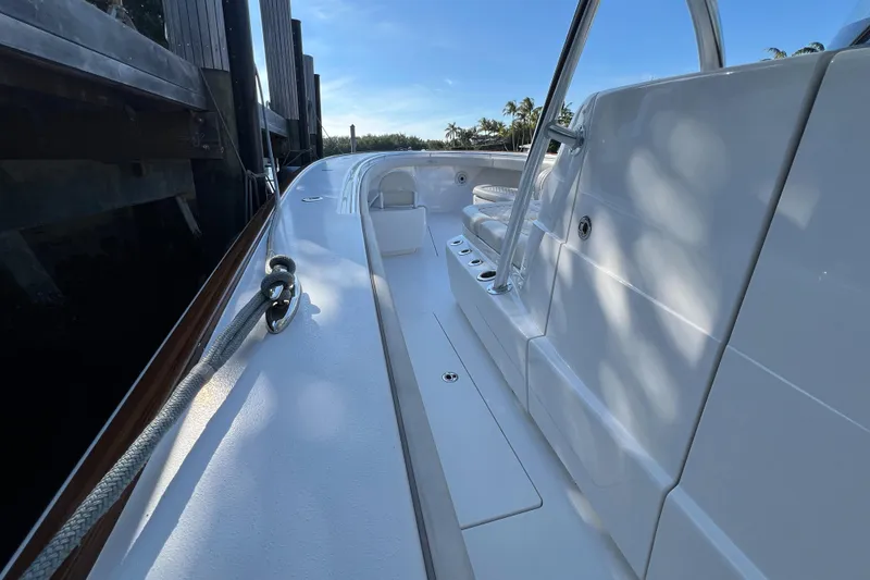 Slide: The Image of 2021 Valhalla Boatworks V-41, sleek white deck, docked under clear blue sky. - 21