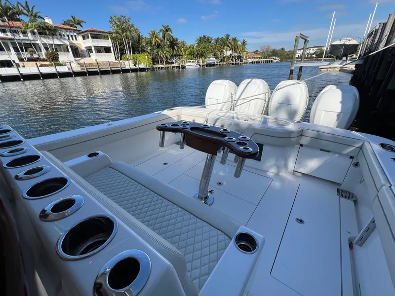 Slide: The Image of 2021 Valhalla Boatworks V-41 on a serene waterfront, showcasing spacious deck and seating. - 3