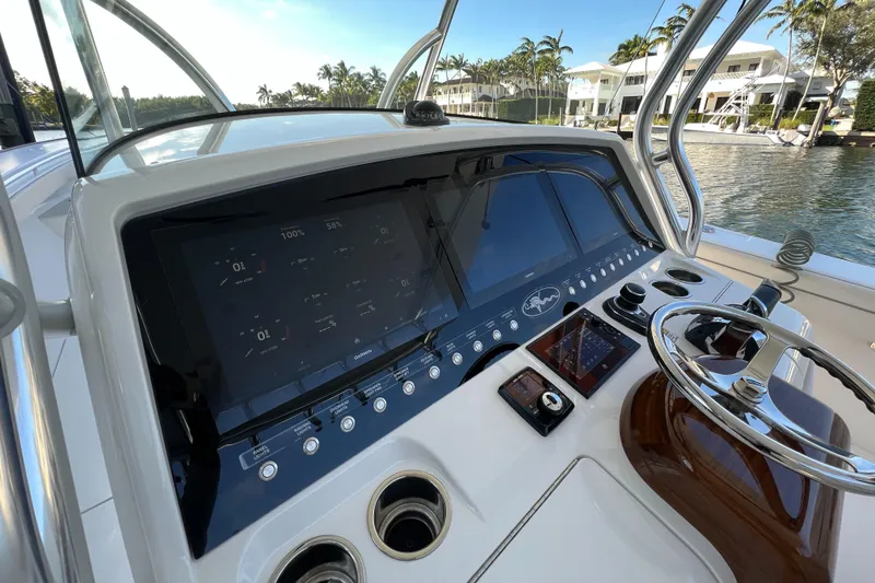 Slide: The Image of 2021 Valhalla Boatworks V-41 helm with modern controls and waterfront view. - 7