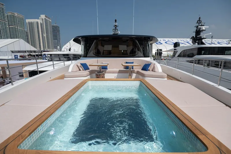 Slide: The Image of Luxurious 2026 Majesty 111 yacht with pool and seating area on deck. - 14