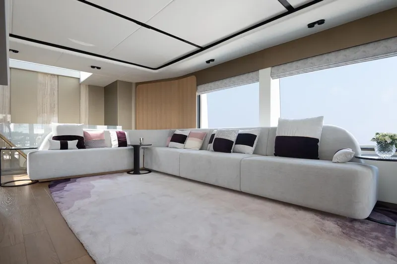 Slide: The Image of Luxurious yacht interior with modern white sectional sofa, large windows, and elegant decor. - 21