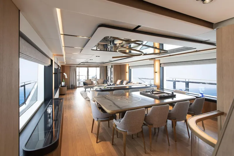 Slide: The Image of Luxurious interior of 2026 Majesty 111 yacht with elegant dining area and panoramic windows. - 23