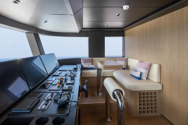 Slide: The Image of Luxurious interior of 2026 Majesty 111 yacht with modern control panel and seating area. - 26