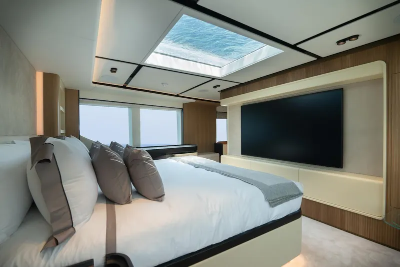 Slide: The Image of Luxurious bedroom interior of 2026 Majesty 111 yacht with skylight and large TV. - 28