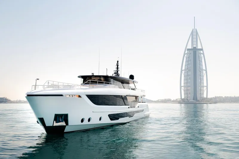 Slide: The Image of Luxury Majesty 111 yacht cruising near iconic Dubai landmark, 2026 model. - 3
