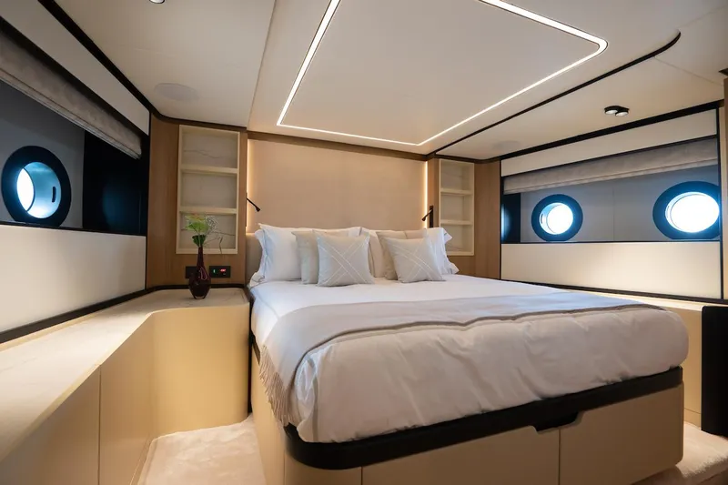 Slide: The Image of Luxurious bedroom interior on 2026 Majesty 111 yacht with modern design and porthole windows. - 39