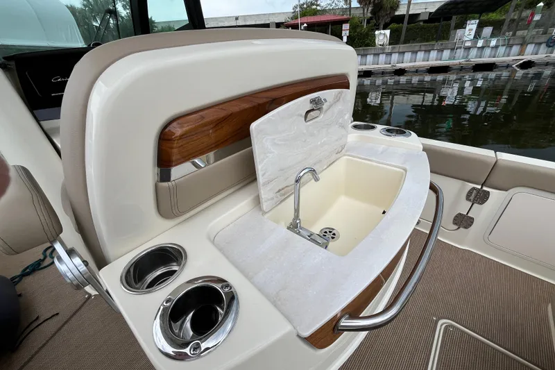 Slide: The Image of Luxury sink area on 2025 Chris-Craft Catalina 28 boat, featuring cup holders and elegant design. - 11
